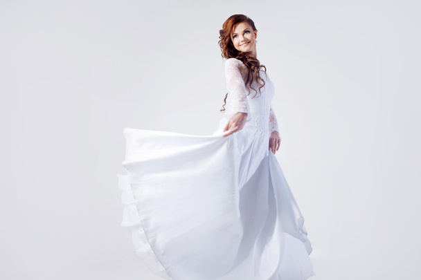 Beautiful bride in wedding dress, white background - Фото, зображення