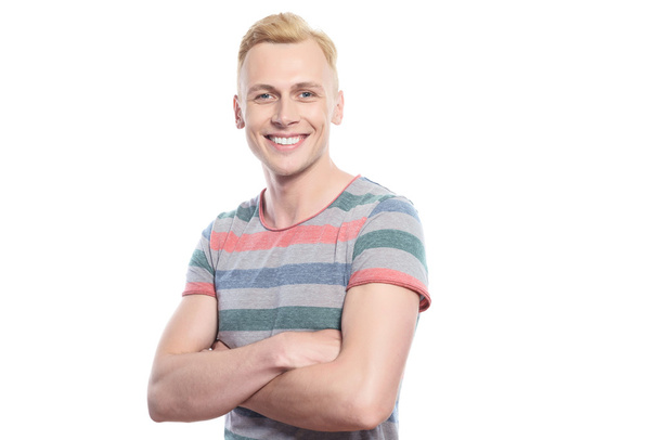 Smiling blond man with crossed arms  - Fotó, kép