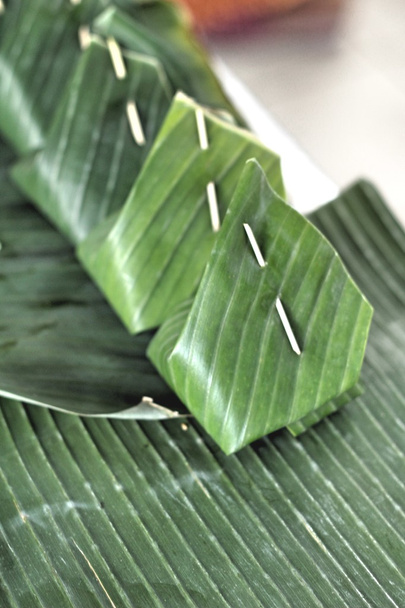 Sticky rice with custard wrapped in banana leaves. - Photo, Image
