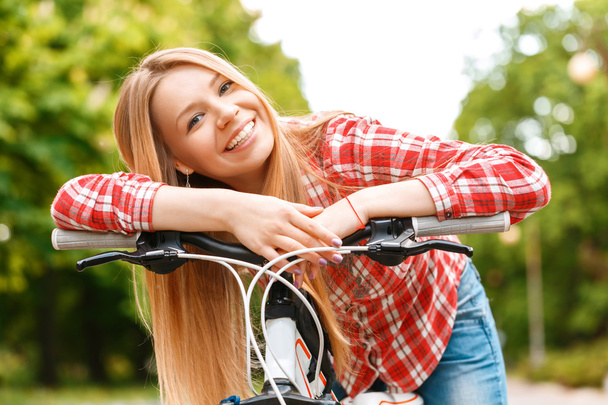 Blond lady with her bike  - Photo, image