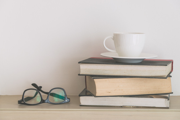 Coffee cup with books and eyeglasses - Photo, Image