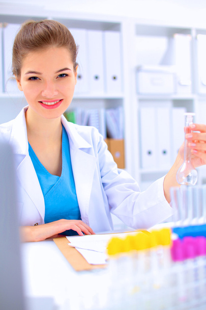 Woman researcher is surrounded by medical vials and flasks, isolated on white background - Φωτογραφία, εικόνα