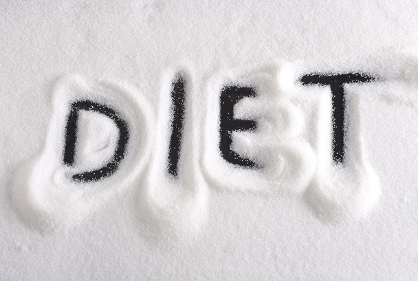 Диетическое слово, написанное пальцем на куче сахара в диете и концепции здорового питания
 - Фото, изображение