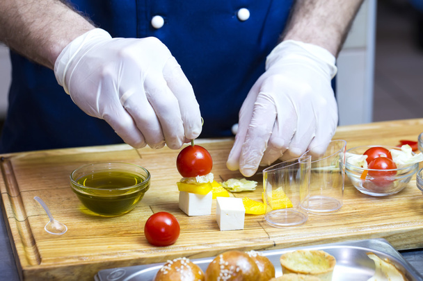 cook prepares canapes in the kitchen - Foto, Imagen