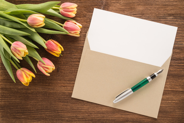 Flowers, envelope and pen - Photo, Image
