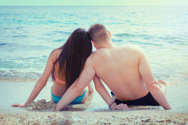 Lovers enjoying on sandy bech in sunbathing - Photo, Image