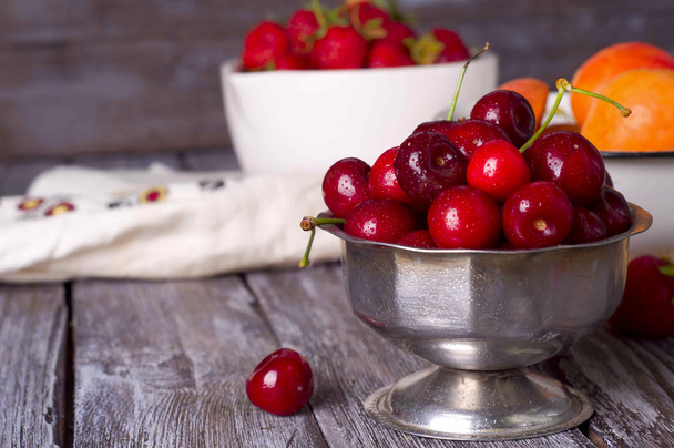fresh cherries on wooden table - Fotó, kép