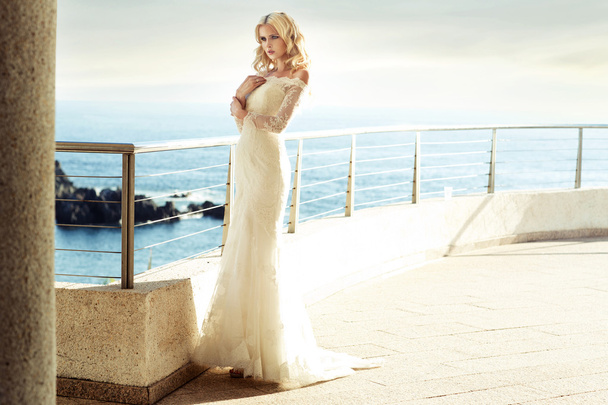 Calm blond bride waiting for her husband - 写真・画像