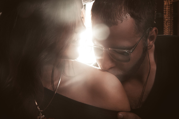 handsome man kissing her shoulder in studio - Valokuva, kuva
