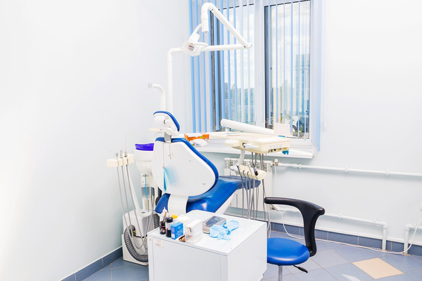 Dentist tools and chair in a dentist office - Foto, imagen