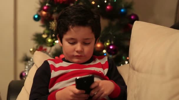 sweet child using and playing smartphone - Imágenes, Vídeo