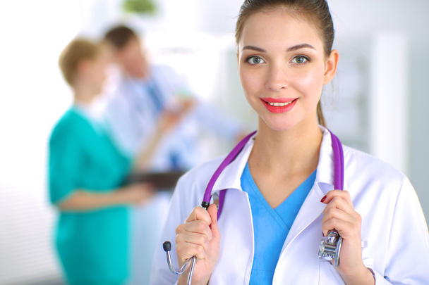 Woman doctor standing with stethoscope at hospital  - Фото, зображення