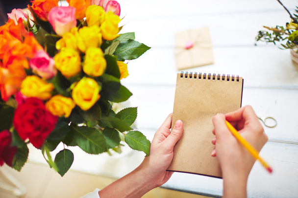 florist with pencil making notes - Фото, зображення