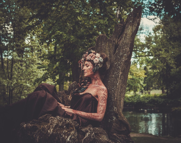 Nymph sitting on her throne in a magical forest  - Photo, Image