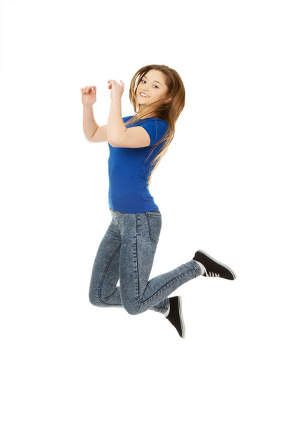 Happy jumping teenager. - Фото, изображение