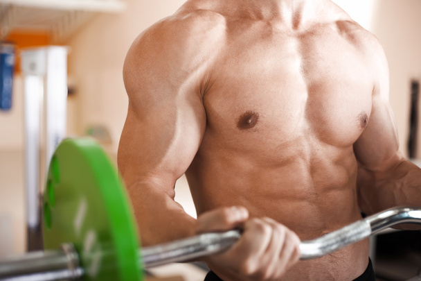 Muscular man lifting barbell - Photo, Image