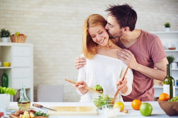 man kissing his wife  in kitchen - Фото, зображення
