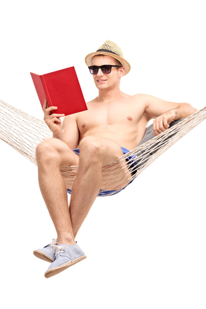 Handsome guy in a hammock reading book - Zdjęcie, obraz