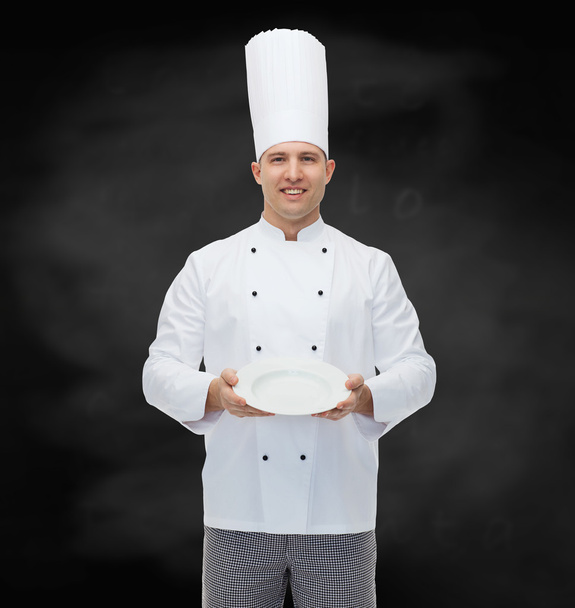 happy male chef cook showing empty plate - Fotó, kép