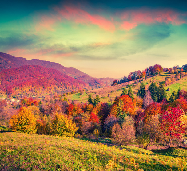 Colorful autumn sunset in mountain village - Photo, Image