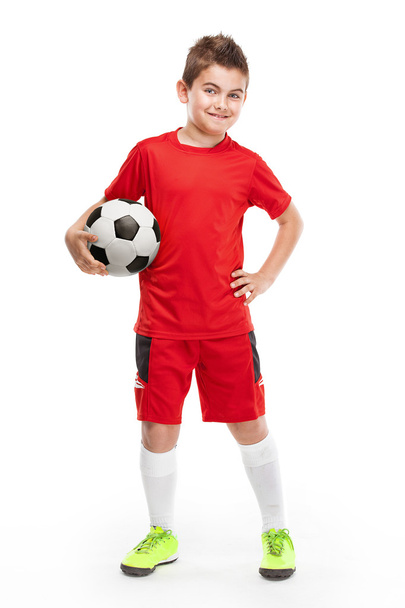 standing young soccer player holding football - Foto, Imagen