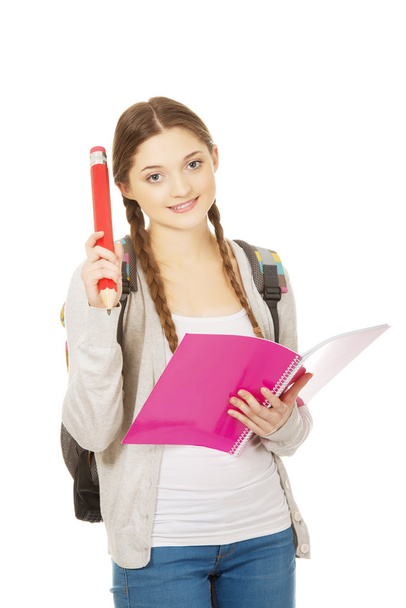 Happy student woman with big pencil. - Foto, afbeelding