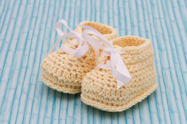 Pale Yellow Baby Booties on wood background - Photo, Image