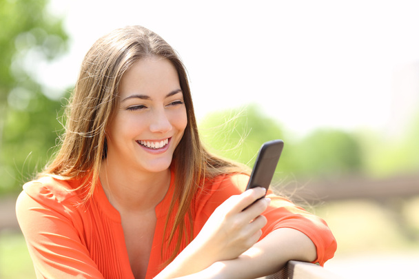 Girl using a smart phone in summer - Фото, зображення