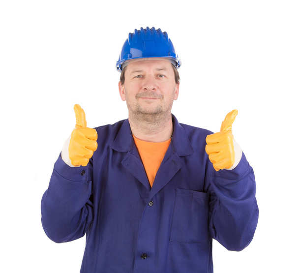 Worker in blue helmet and yellow gloves - Valokuva, kuva