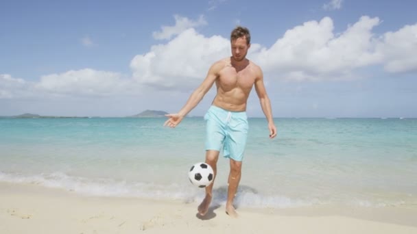 man on beach playing football - Video, Çekim