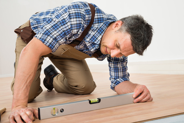 Carpenter Installing New  Floor - Photo, image