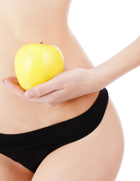 vrouwelijk lichaam en apple - Foto, afbeelding