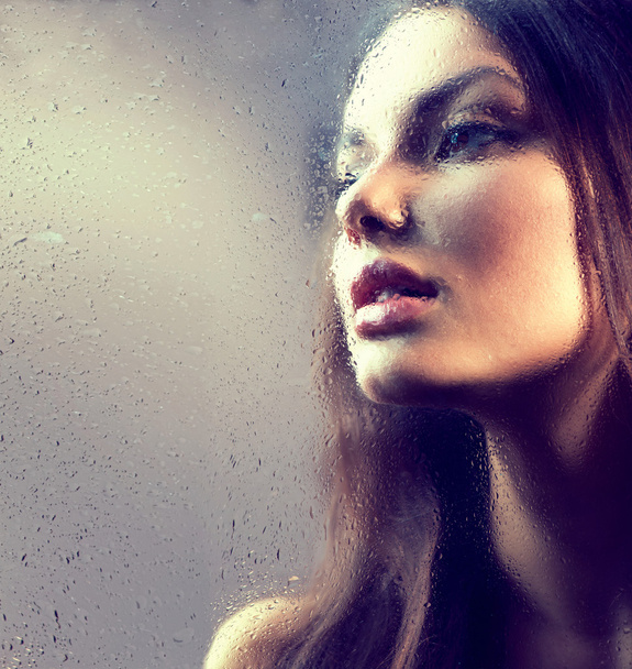 beauty girl behind  wet glass. - Foto, Imagem