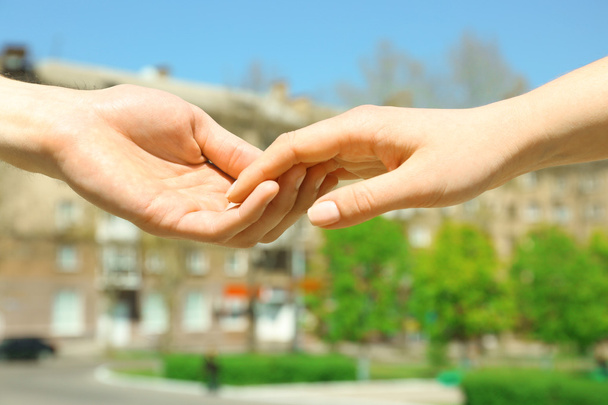 Couple holding hands on blurred background - Foto, imagen