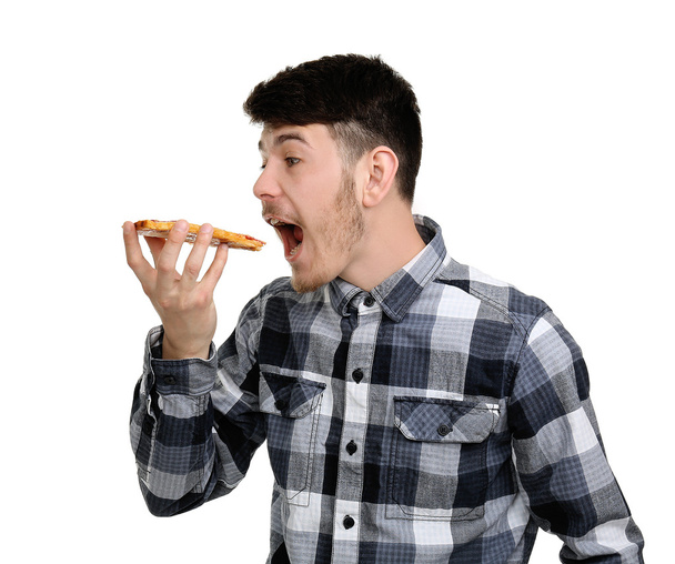 Young man eating piece of pizza isolated on white - Foto, immagini