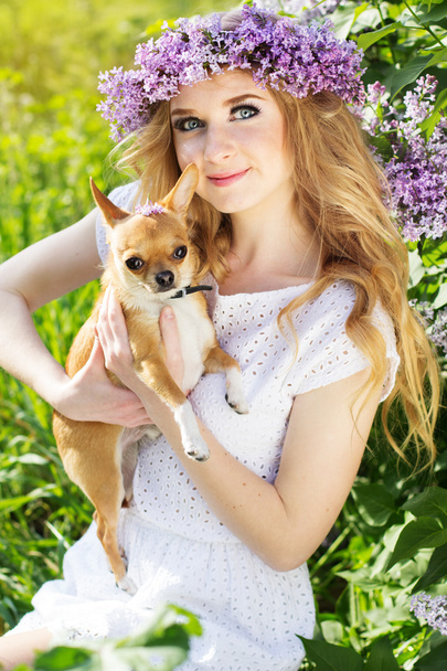 Adolescente chica está sosteniendo su pequeño perro
 - Foto, imagen