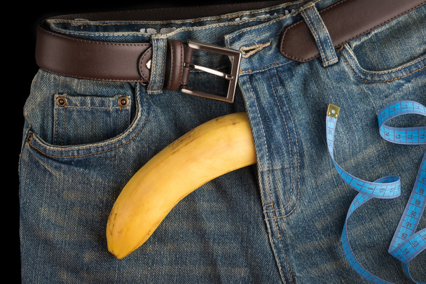 Big Banana like the penis, centimeter and men's jeans - Photo, Image