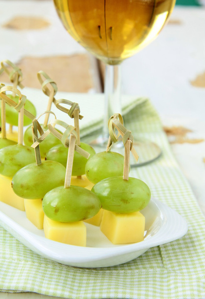 Appetizer canape cheese with white grapes on bamboo skewers - Photo, Image