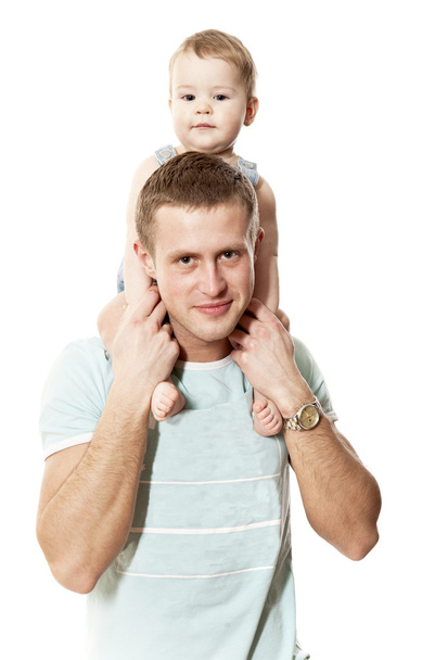 The young man holds the child on shoulders - Фото, изображение