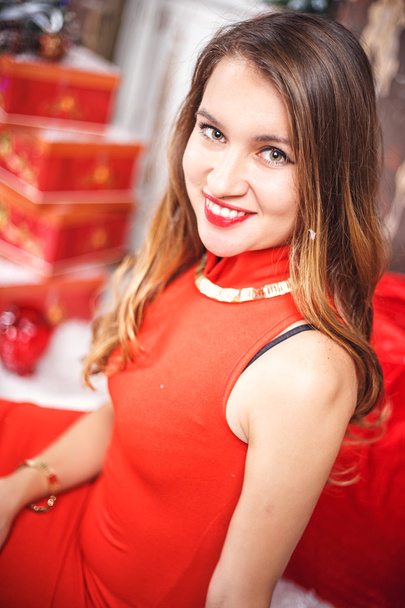 Portrait of beautiful sweet young woman in gorgeous evening dress over Christmas background. - Φωτογραφία, εικόνα