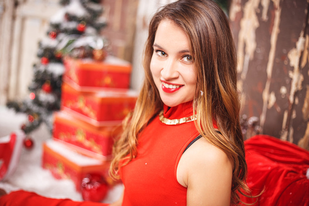 Portrait of beautiful sweet young woman in gorgeous evening dress over Christmas background. - Fotoğraf, Görsel