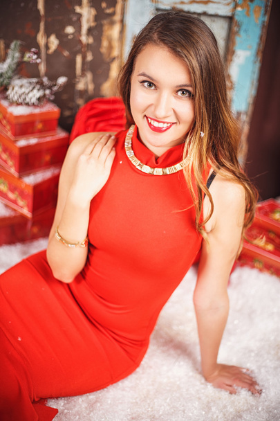 Portrait of beautiful sweet young woman in gorgeous evening dress over Christmas background. - Фото, зображення