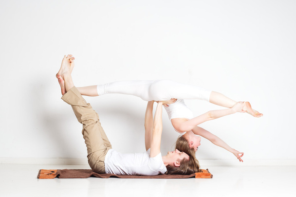 Young couple in yoga pose - Fotoğraf, Görsel