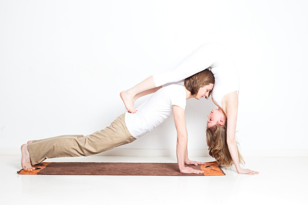 Young couple in yoga pose - Фото, зображення