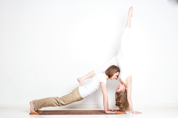 Young couple in yoga pose - Fotó, kép