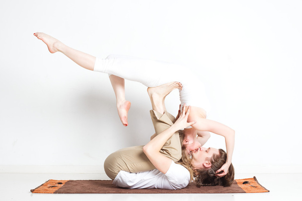 Young couple in yoga pose - Foto, Imagen
