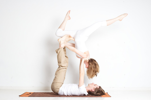 Young couple in yoga pose - Φωτογραφία, εικόνα