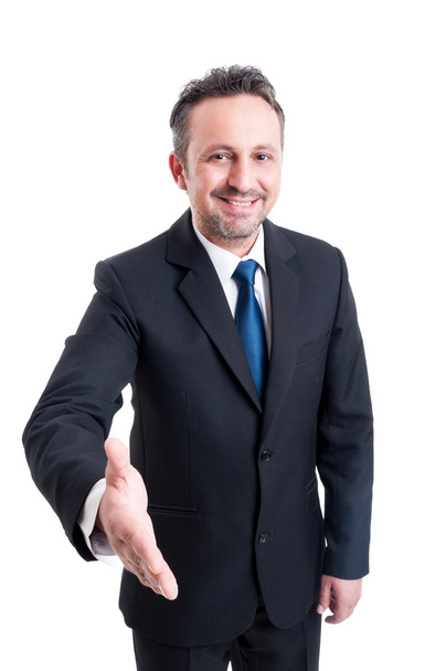 Friendly and smiling business man leaning for hand shake - Фото, изображение