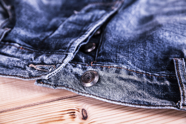Clothing. jeans and a button in the foreground - Foto, imagen