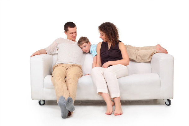 Parents with son on white leather sofa - Zdjęcie, obraz
